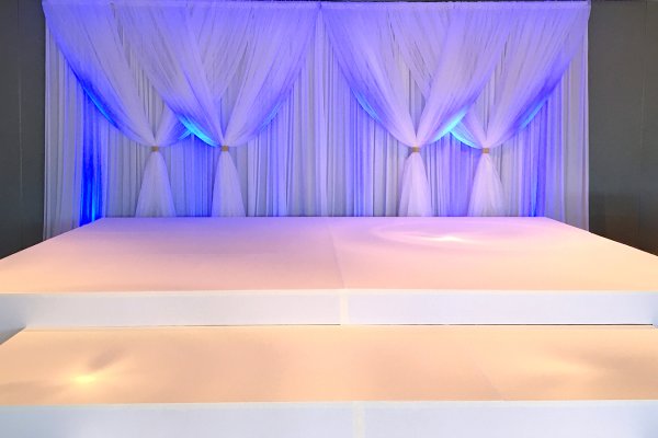 Custom White Stage with Drape & Lighting